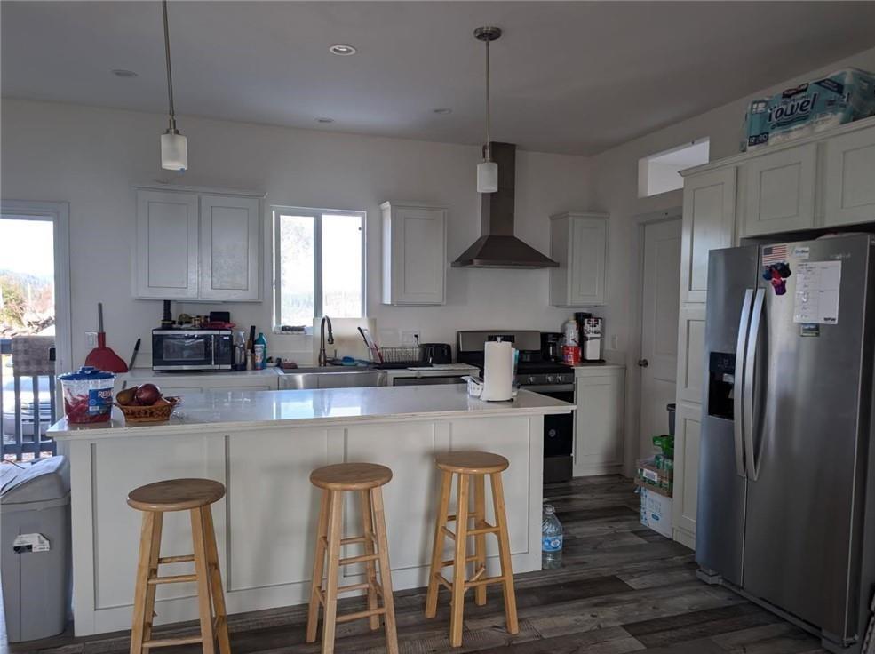 709 Encina Grande Road Berry Creek, CA 95916 - Photo 7 of 12 a kitchen with stainless steel appliances a sink a stove a refrigerator and chairs