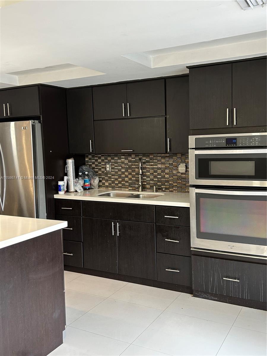 a kitchen with stainless steel appliances wooden cabinets and stove