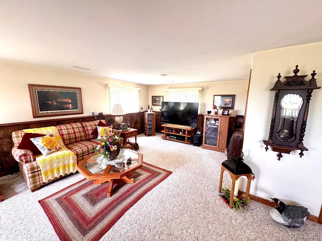 6686 South Schott Road Mayville, MI 48744 - Photo 19 of 25 Expansive room featuring wall-to-wall carpeting and wood paneling
