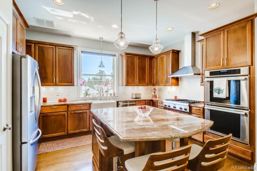 3234 Stuart Street Denver, CO 80212 - Photo 15 of 40 a kitchen with stainless steel appliances granite countertop a sink stove and refrigerator