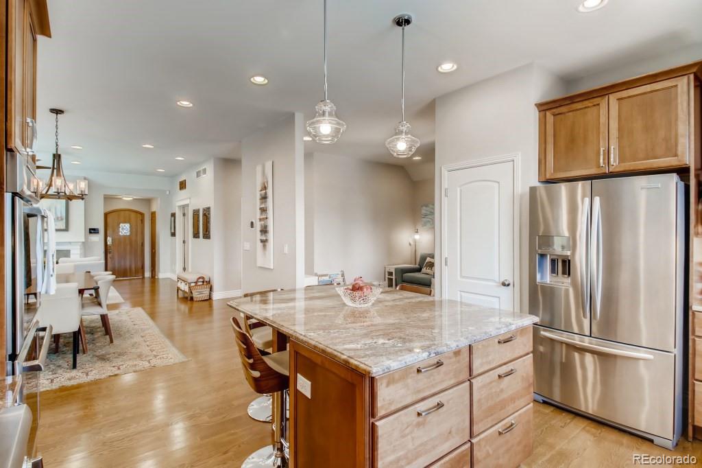 3234 Stuart Street Denver, CO 80212 - Photo 17 of 40 a kitchen with stainless steel appliances granite countertop a refrigerator a sink dishwasher and a stove with wooden floor
