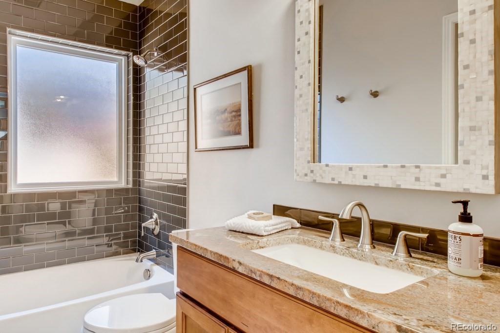 3234 Stuart Street Denver, CO 80212 - Photo 18 of 40 a bathroom with a granite countertop sink mirror and bathtub
