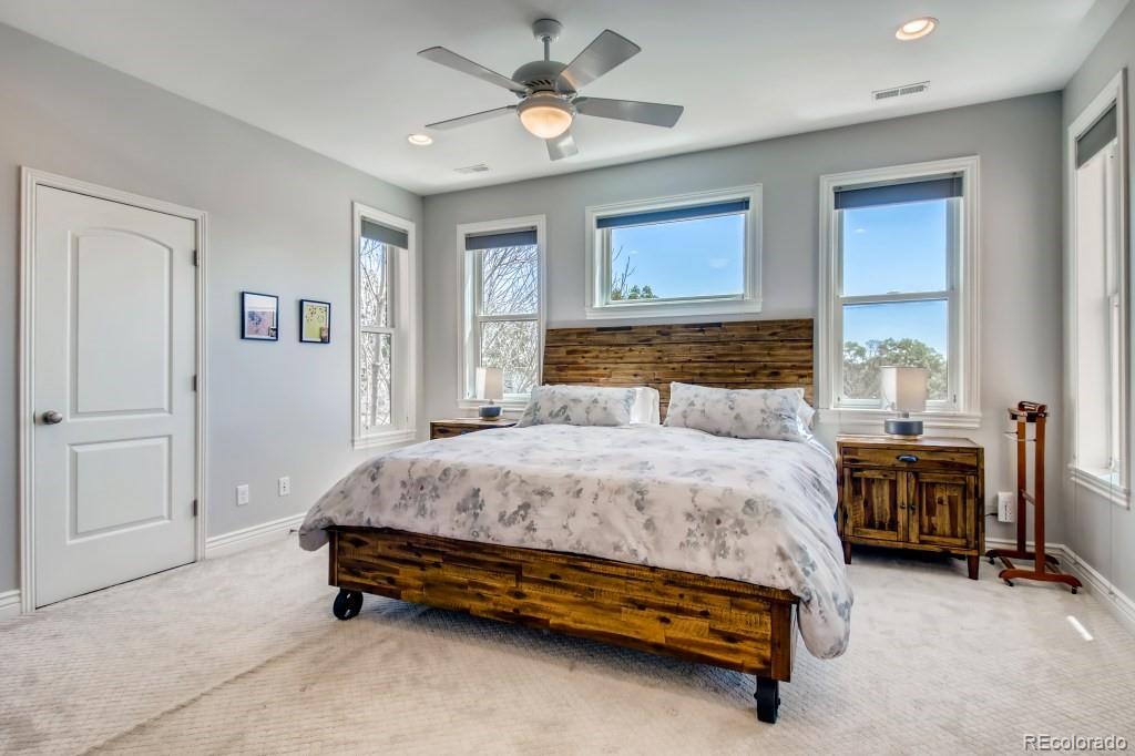 3234 Stuart Street Denver, CO 80212 - Photo 19 of 40 a bedroom with a bed and a chandelier