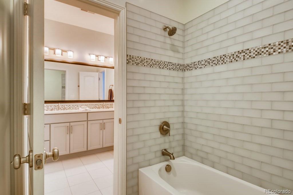 3234 Stuart Street Denver, CO 80212 - Photo 29 of 40 a bathroom with a tub a sink and a shower