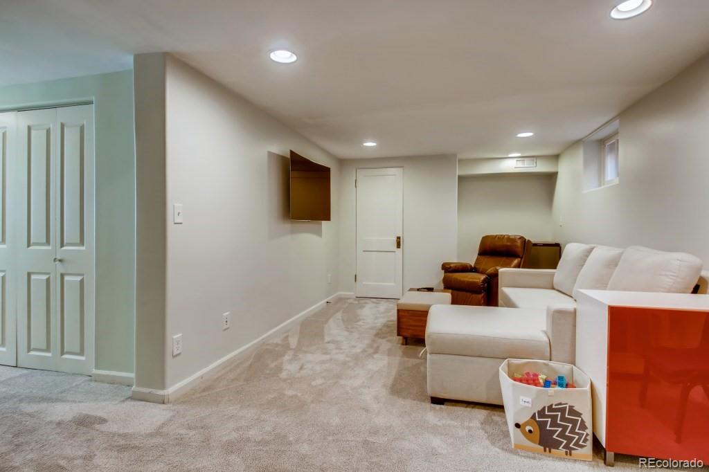 3234 Stuart Street Denver, CO 80212 - Photo 32 of 40 a living room with furniture and a flat screen tv