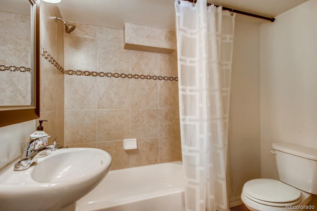 3234 Stuart Street Denver, CO 80212 - Photo 34 of 40 a bathroom with a sink toilet and shower