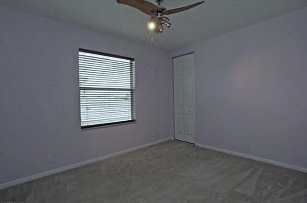 8726 Tally Ho Lane West Palm Beach, FL 33411 - Photo 16 of 33 an empty room with a ceiling fan and window