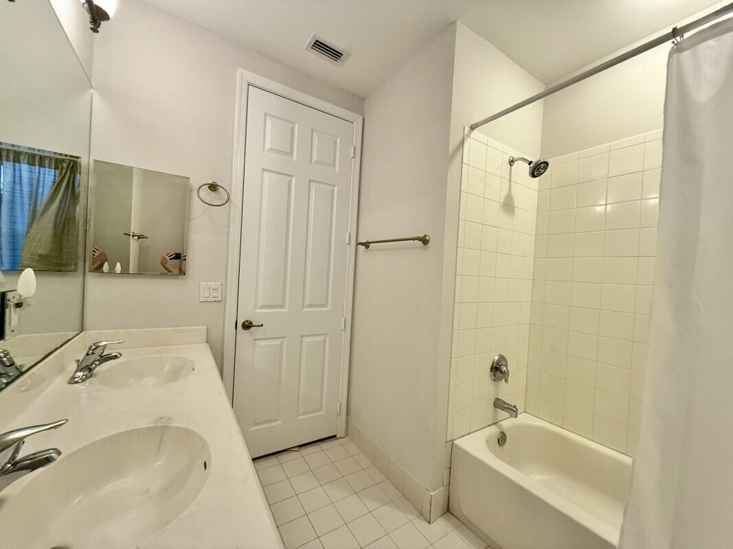 8726 Tally Ho Lane West Palm Beach, FL 33411 - Photo 18 of 33 a bathroom with a tub sink vanity and a shower