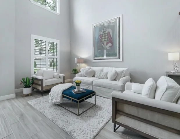 a living room with furniture and wooden floor