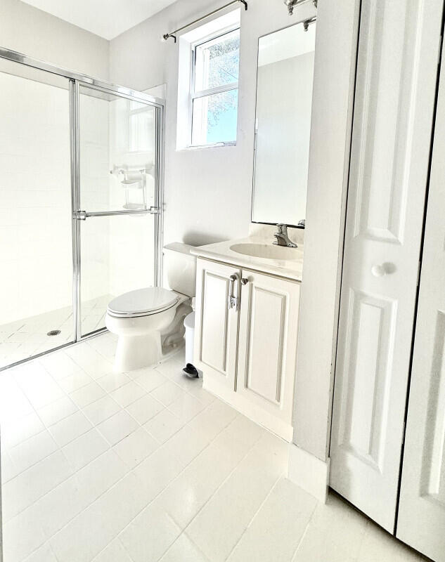 8726 Tally Ho Lane West Palm Beach, FL 33411 - Photo 21 of 33 a bathroom with a toilet a sink and a shower