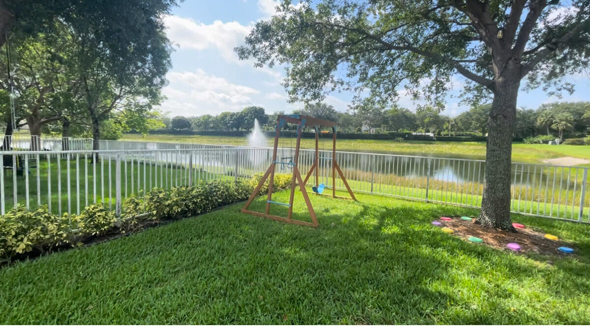 8726 Tally Ho Lane West Palm Beach, FL 33411 - Photo 22 of 33 a view of a lake with a big yard and large trees