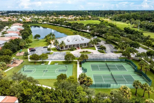 an aerial view of residential houses with outdoor space and swimming pool