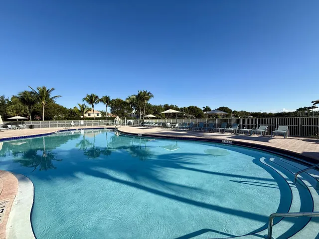 a view of swimming pool with outdoor seating and yard in back