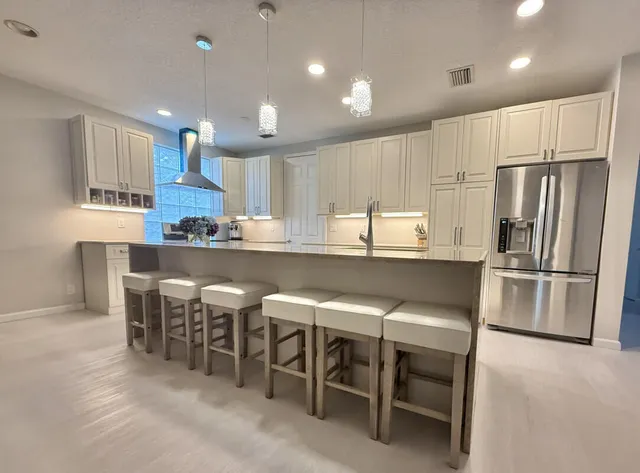 a kitchen with kitchen island wooden cabinets and stainless steel appliances
