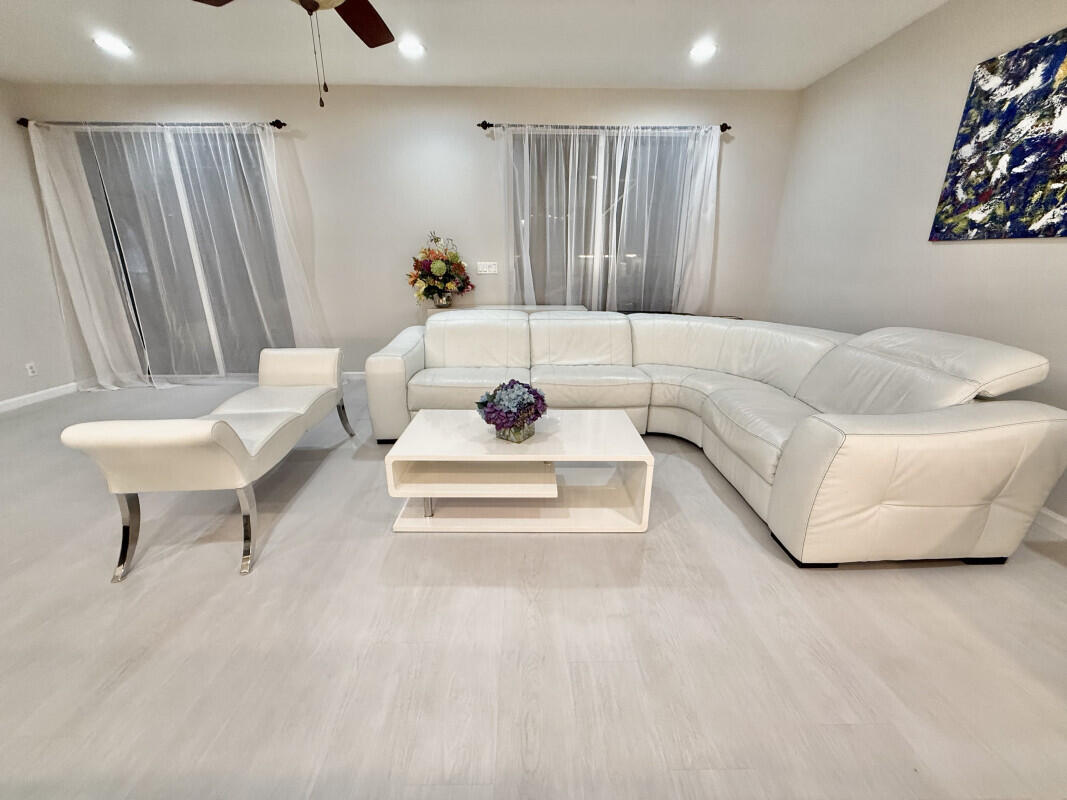 8726 Tally Ho Lane West Palm Beach, FL 33411 - Photo 7 of 33 a living room with furniture and a white walls