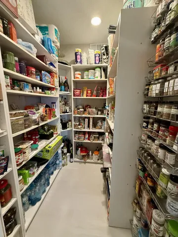 a cabinet with wine glasses in front of it