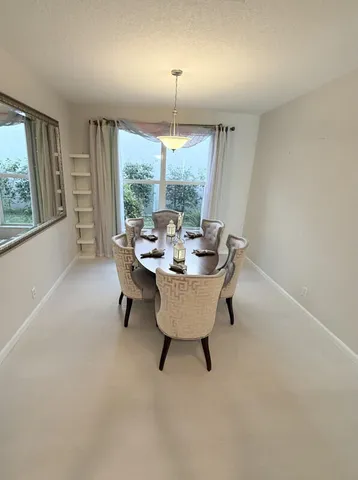 a dining room with furniture and window