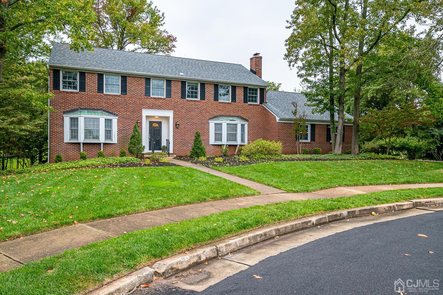 8 Bluebird Court Edison, NJ 08820 - Photo 12 of 15 a front view of a house with a garden and trees