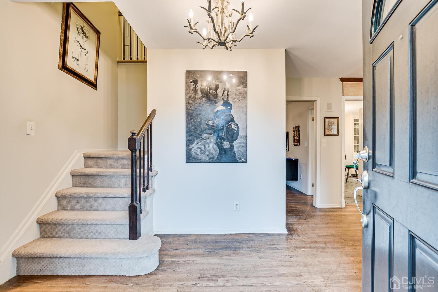 8 Bluebird Court Edison, NJ 08820 - Photo 15 of 15 a view of staircase with white walls and a painting on the wall