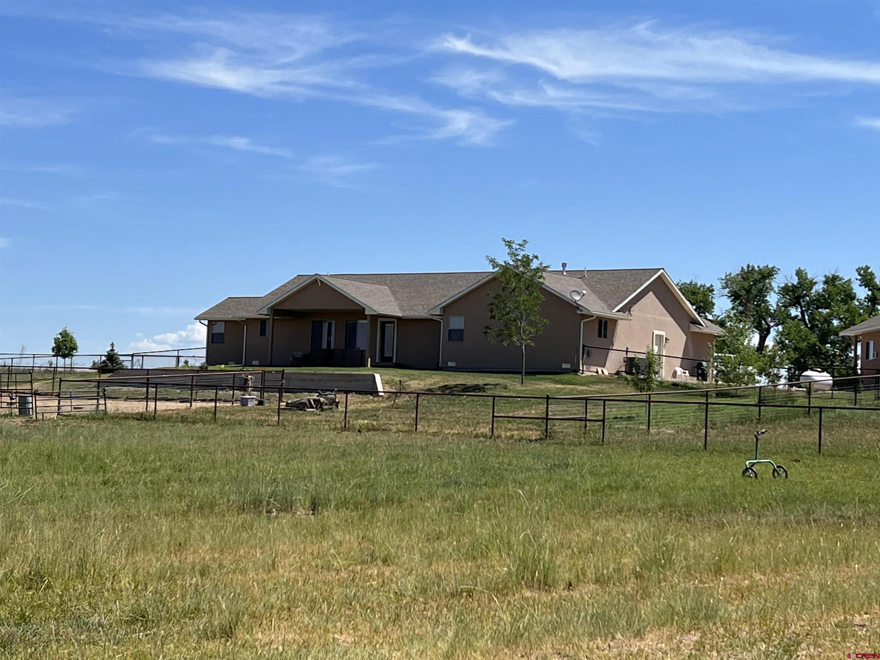 12562 Road 23.25 Loop Cortez, CO 81321 - Photo 18 of 30 a view of a house with a yard
