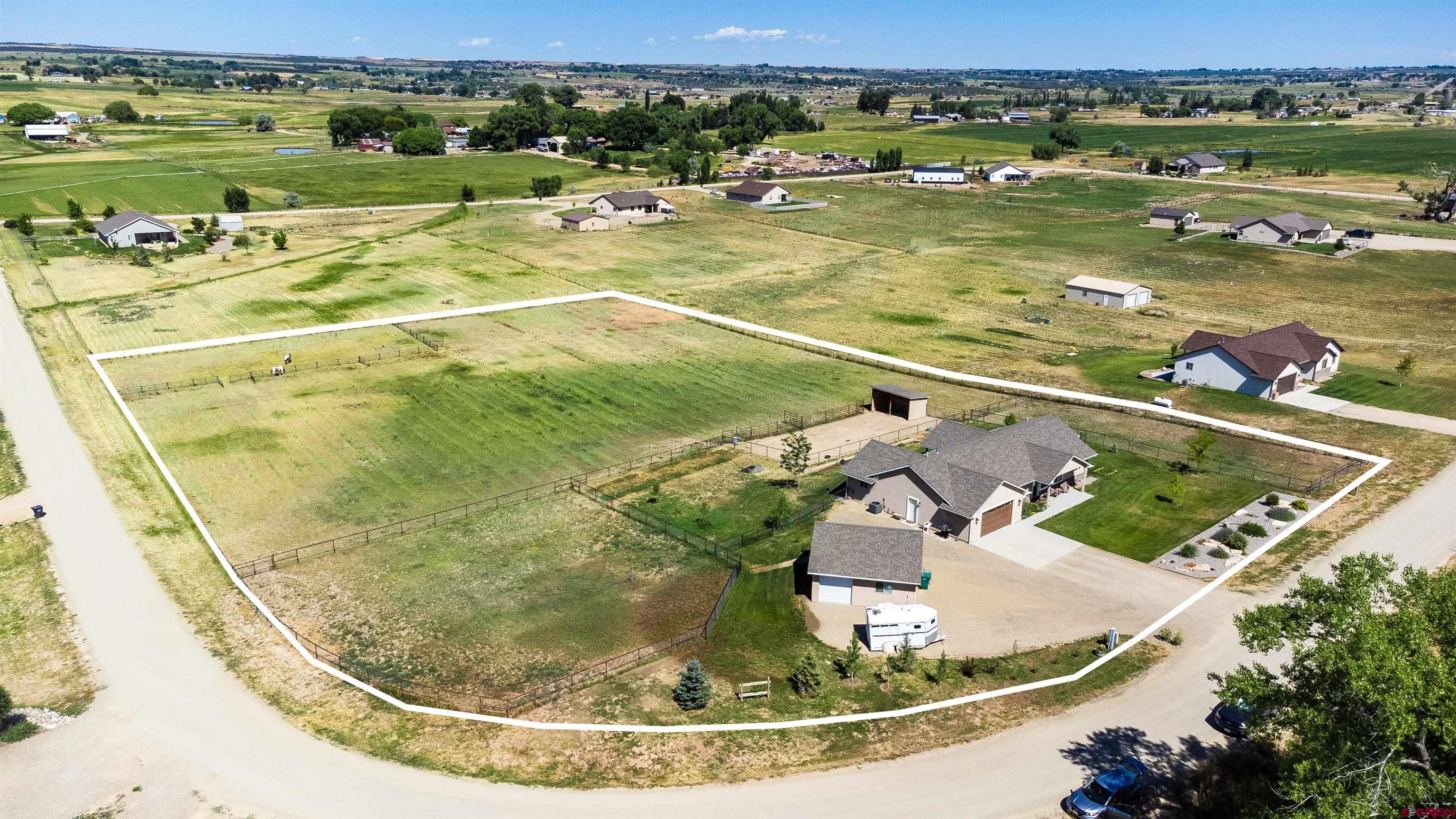 12562 Road 23.25 Loop Cortez, CO 81321 - Photo 23 of 30 an aerial view of a swimming pool with a yard and mountain view