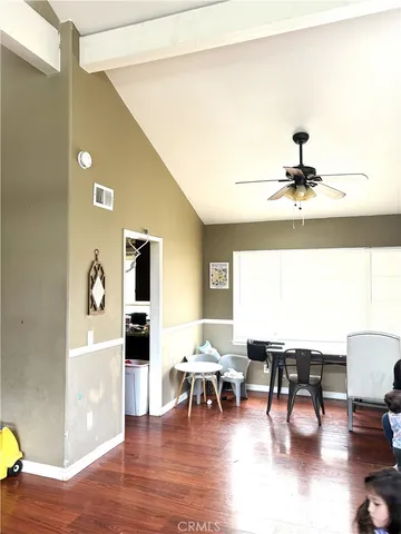 a living room with chairs and a piano table