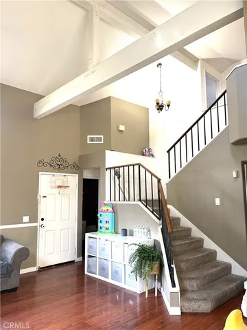 a view of entryway and hall with wooden floor