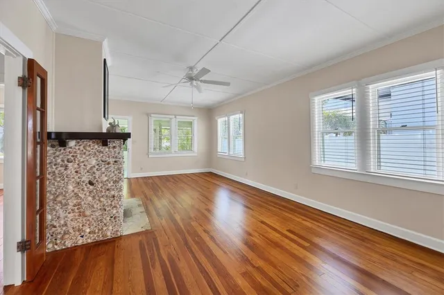 a view of wooden floor and windows in a room