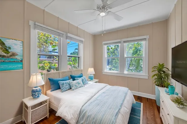 a bedroom with a bed table and a window