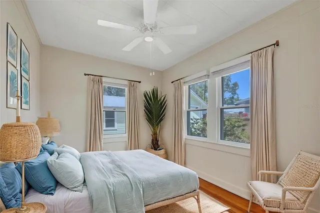 a bedroom with a bed and a window