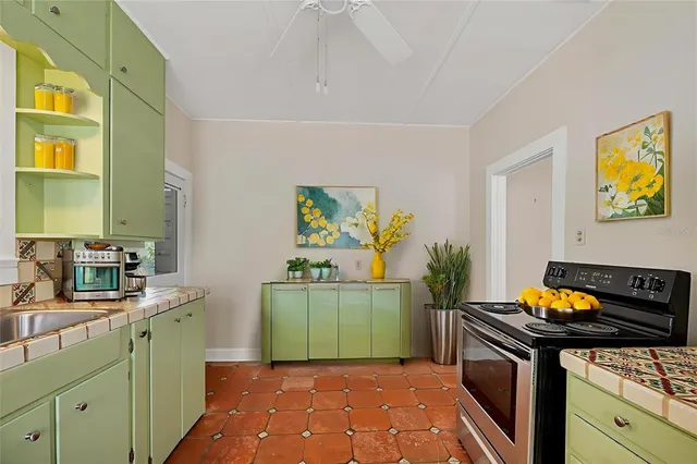 a kitchen with a sink a stove and cabinets