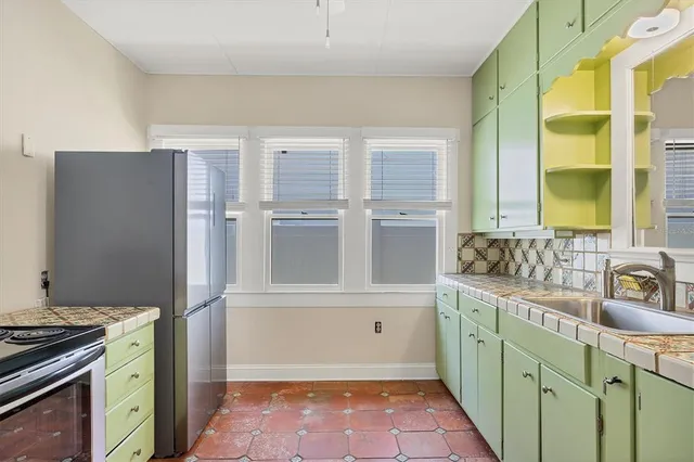 a kitchen with a refrigerator and a sink