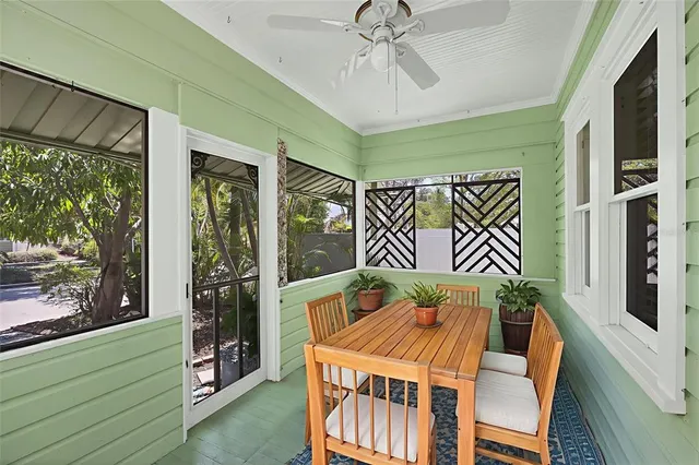 a bedroom with furniture and a large window