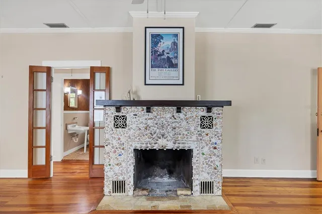 a living room with a fireplace and wooden floor