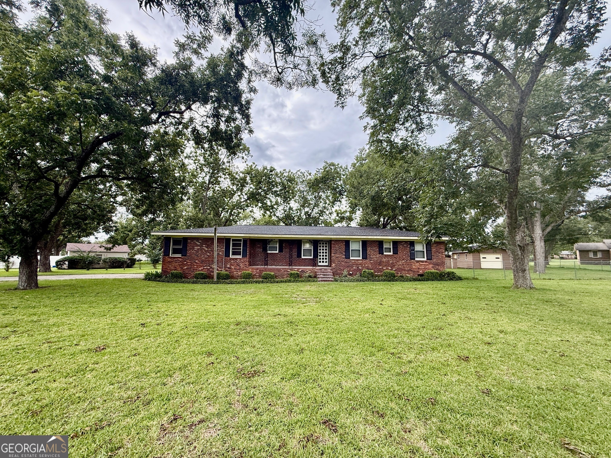 a front view of house with yard and trees