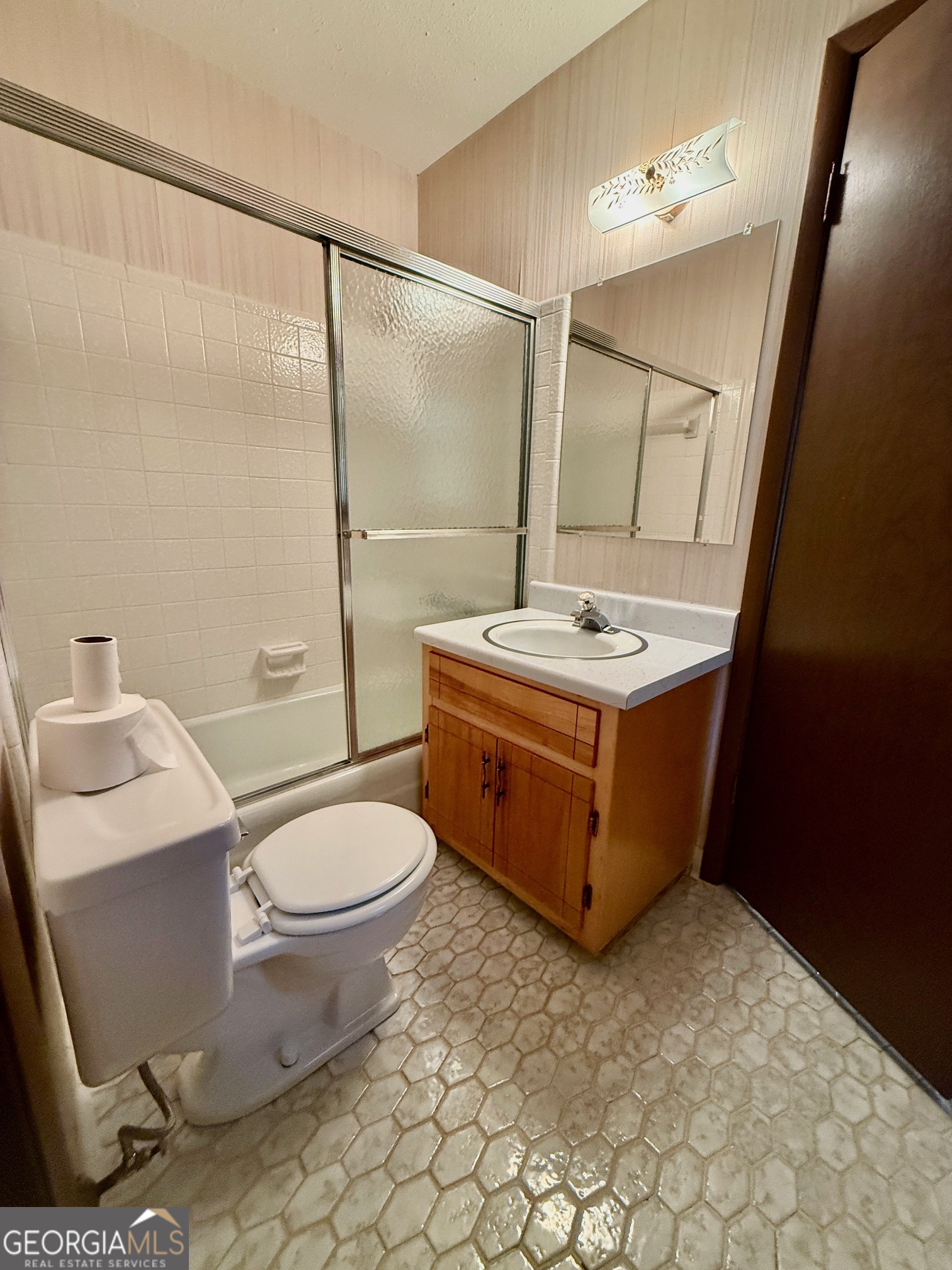 5741 Lawrence Court Macon, GA 31216 - Photo 10 of 22 a bathroom with a toilet sink and mirror