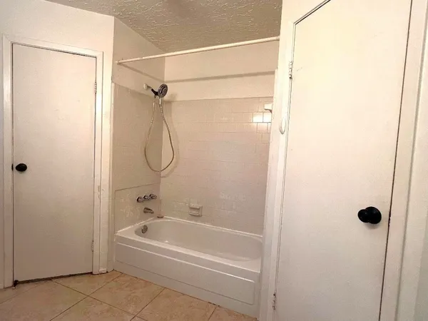 a bathroom with a glass shower door