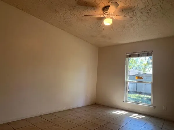 an empty room with windows and entrance