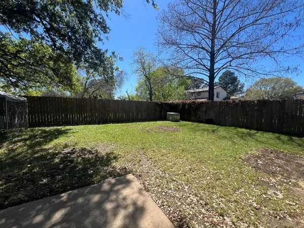 a view of swimming pool with wooden fence