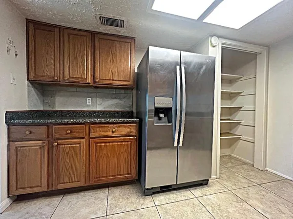 a kitchen with granite countertop cabinets and stainless steel appliances