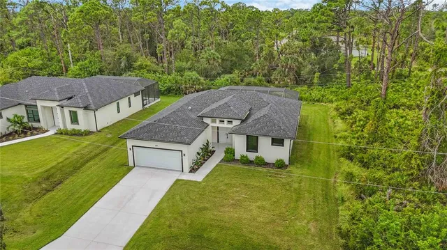 a aerial view of a swimming pool with a yard
