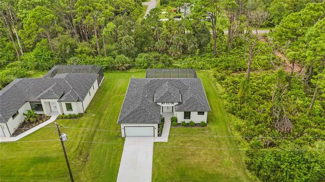 an aerial view of a house with garden space and street view