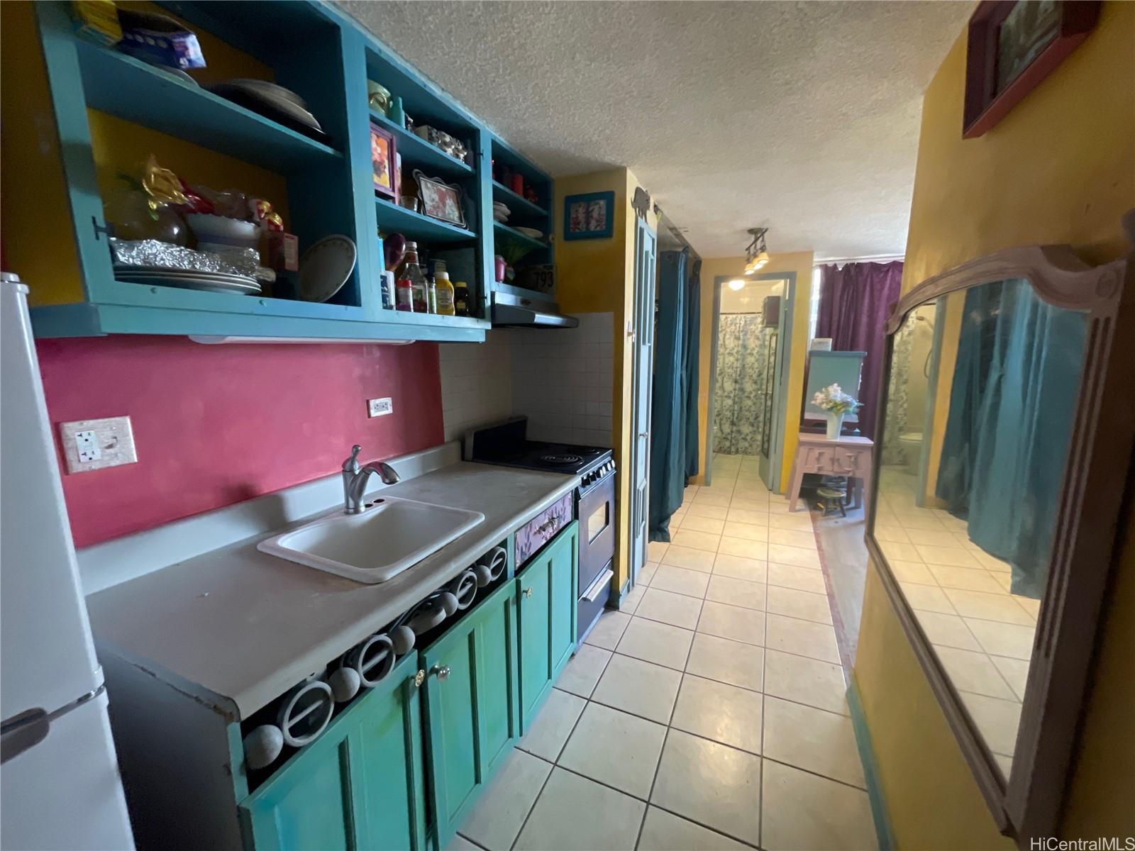 824 Kinau Street, Unit 604 Honolulu, HI 96813 - Photo 2 of 9 a kitchen with stainless steel appliances granite countertop a refrigerator a stove and a sink
