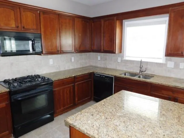 a kitchen with a sink stove and microwave