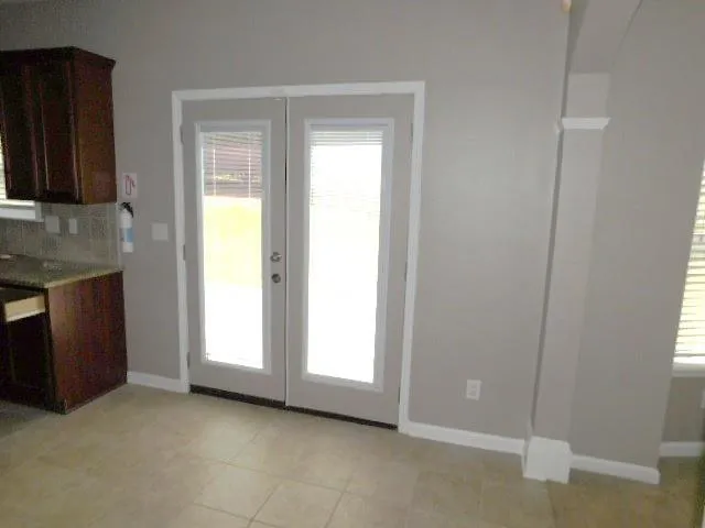 a view of an empty room with a fireplace and a window