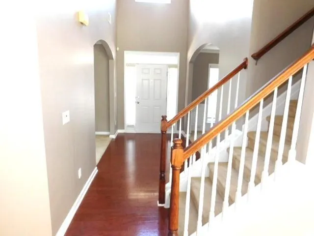 a view of an entryway with wooden floor