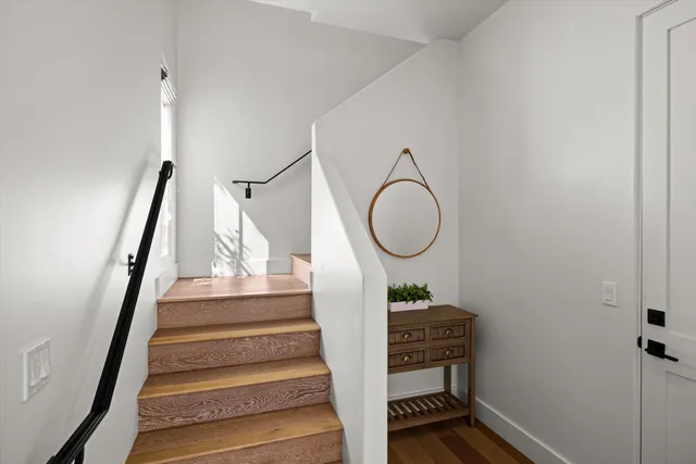 a view of entryway and hall with wooden floor