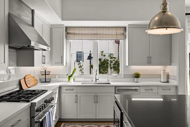 a kitchen with a sink stove and cabinets