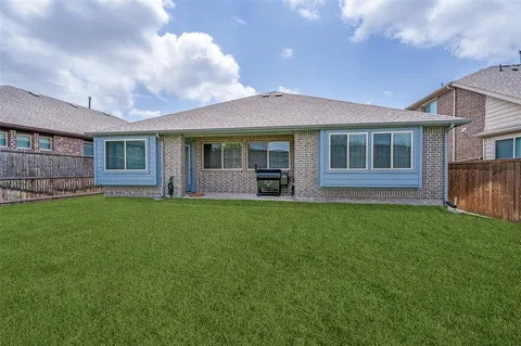 a view of an house with backyard space and garden