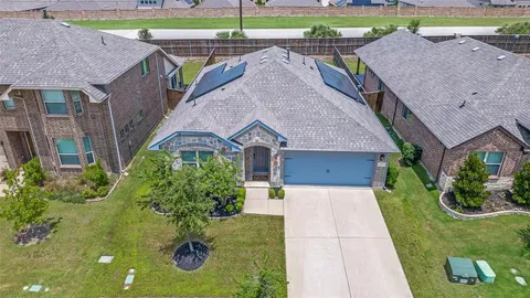 a aerial view of a house with a yard